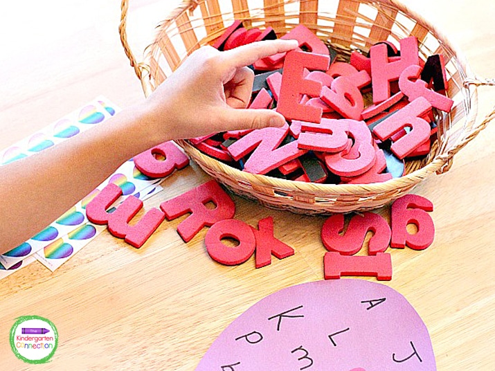 Students pull a letter out of a small basket, identify the letter, and say the letter sound.