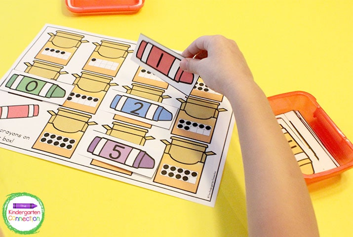 Match the crayon number cards to the corresponding ten frame crayon box on the game mat.