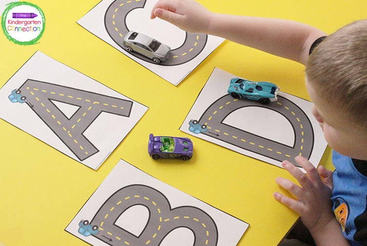 Students use toy cars to practice letter formation by racing up and down the letters on our Road Racers printable.