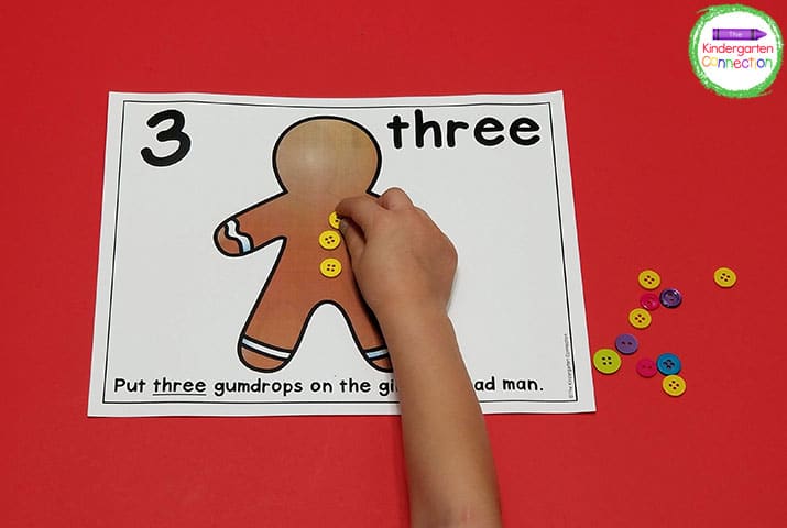 Have kids pick up small objects such as beads or buttons to place on the gingerbread man for "gumdrops."