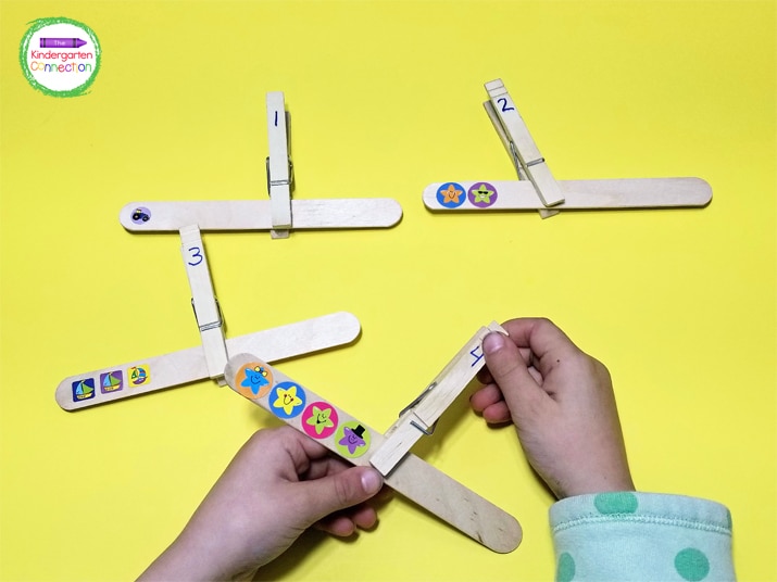 This activity requires only a few simple supplies. Grab some craft sticks, stickers, and clothespins and you're all set.