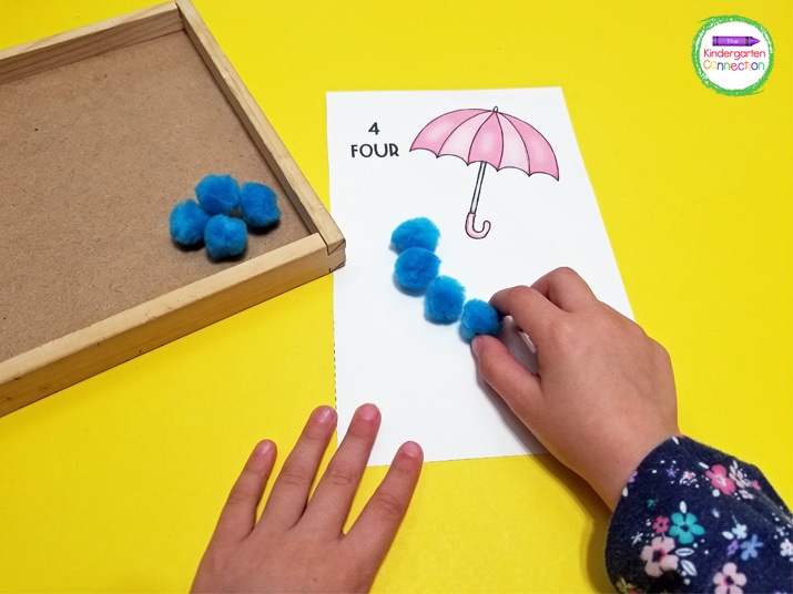 For this fun math center, grab some blue manipulatives like pom poms to create the raindrops for counting.