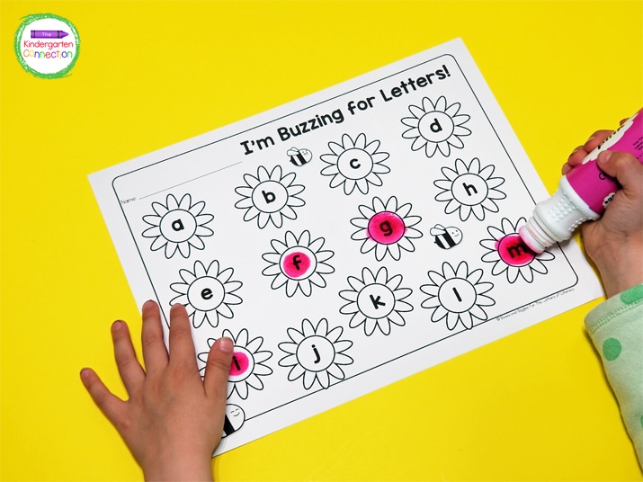 in this letter recognition activity, kids continue to stamp until all flower letters on their recording sheet are filled up.