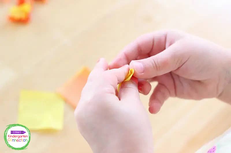 Crumple up a generous amount of both yellow and orange tissue paper squares and set them aside.