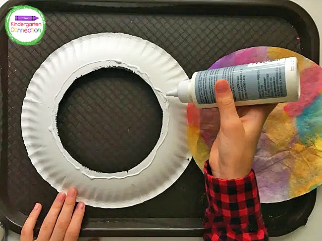 Flip the paper plate over, and apply a thin layer of glue around the inner circle.