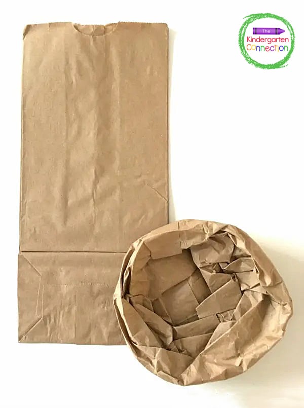 Invite the students to carefully open up the paper lunch bag and roll down the edges of the bag to make the pretend crust.