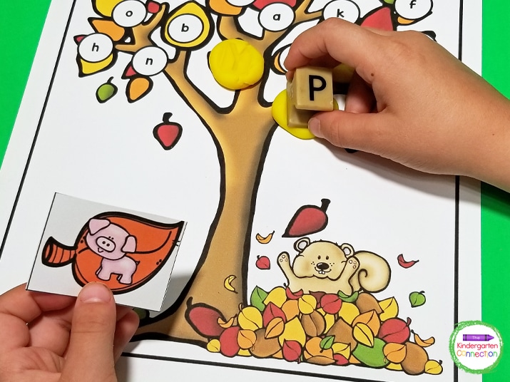 Pick a leaf card, identify the beginning sound, and use letter stamps to stamp the letter into a play dough ball on the mat.