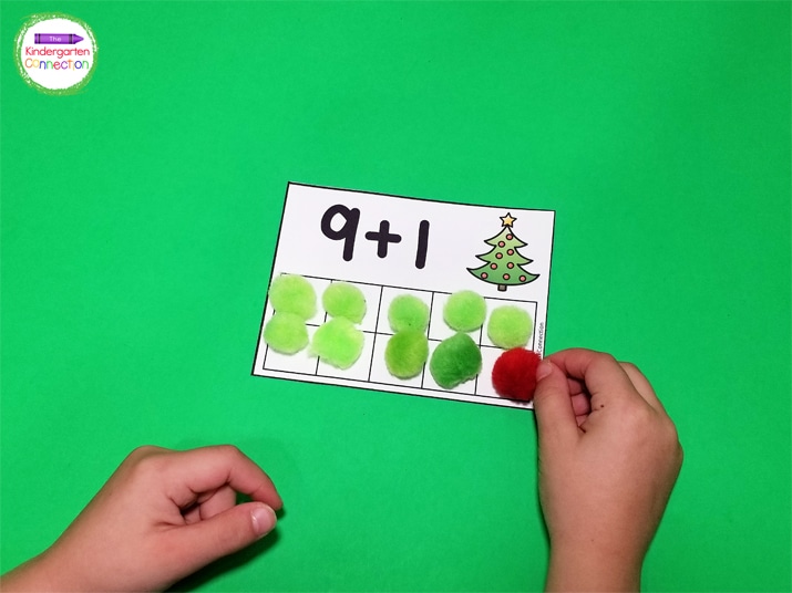 Use manipulatives like pom poms to add the numbers on the cards.