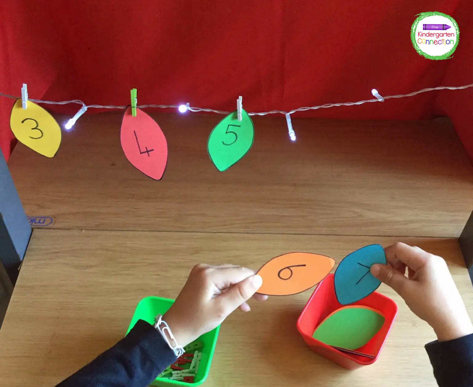 Now, clip your first light bulb onto the string. Find the next number and clip it on too.