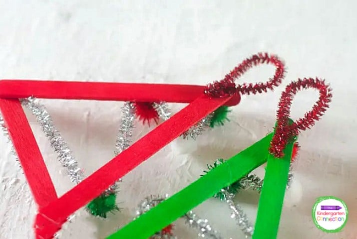 Make a loop with the red pipe cleaner and glue it to the back of the ornament for hanging.
