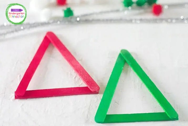 Begin by gluing 3 red popsicle sticks in a triangle. Then repeat with green popsicle sticks.