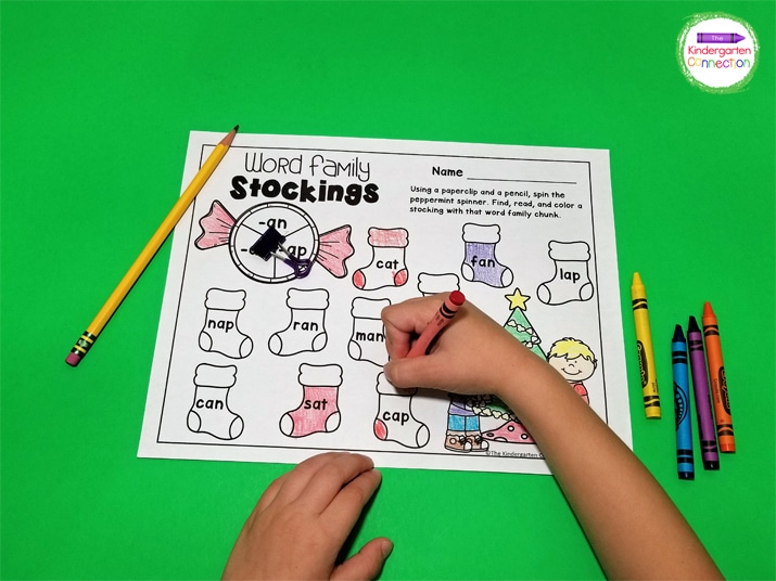 A binder clip and a pencil work great as a spinner for these Christmas word family games.