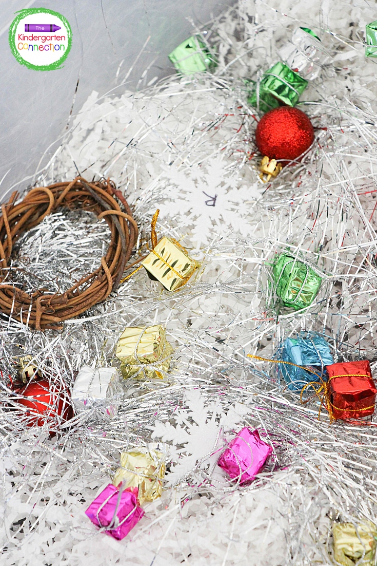 Mini wreaths, small ornaments, and mini present boxes are great additions to this sensory bin.