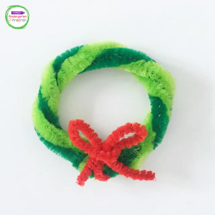 To make the bow, take each end of the mini pipe cleaner to form a loop and twist the loops together.