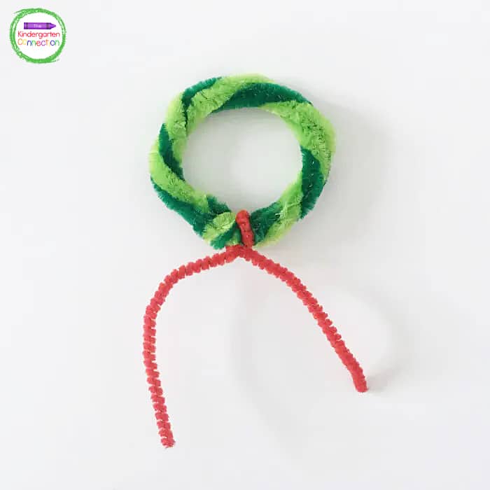 Where the ends of the pipe cleaners are twisted together, add the red mini pipe cleaner and twist it onto the ring.