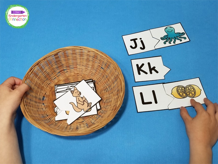 We spread the letter cards out on the table and then place the picture cards in a small basket.