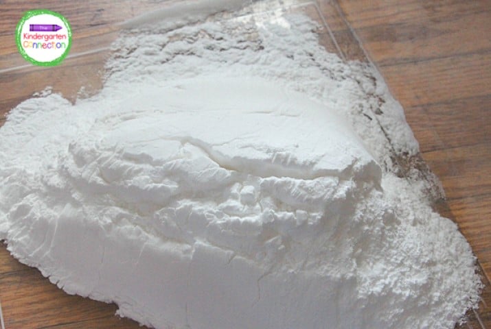 Pour approximately 4 pounds of baking soda into a large bin.