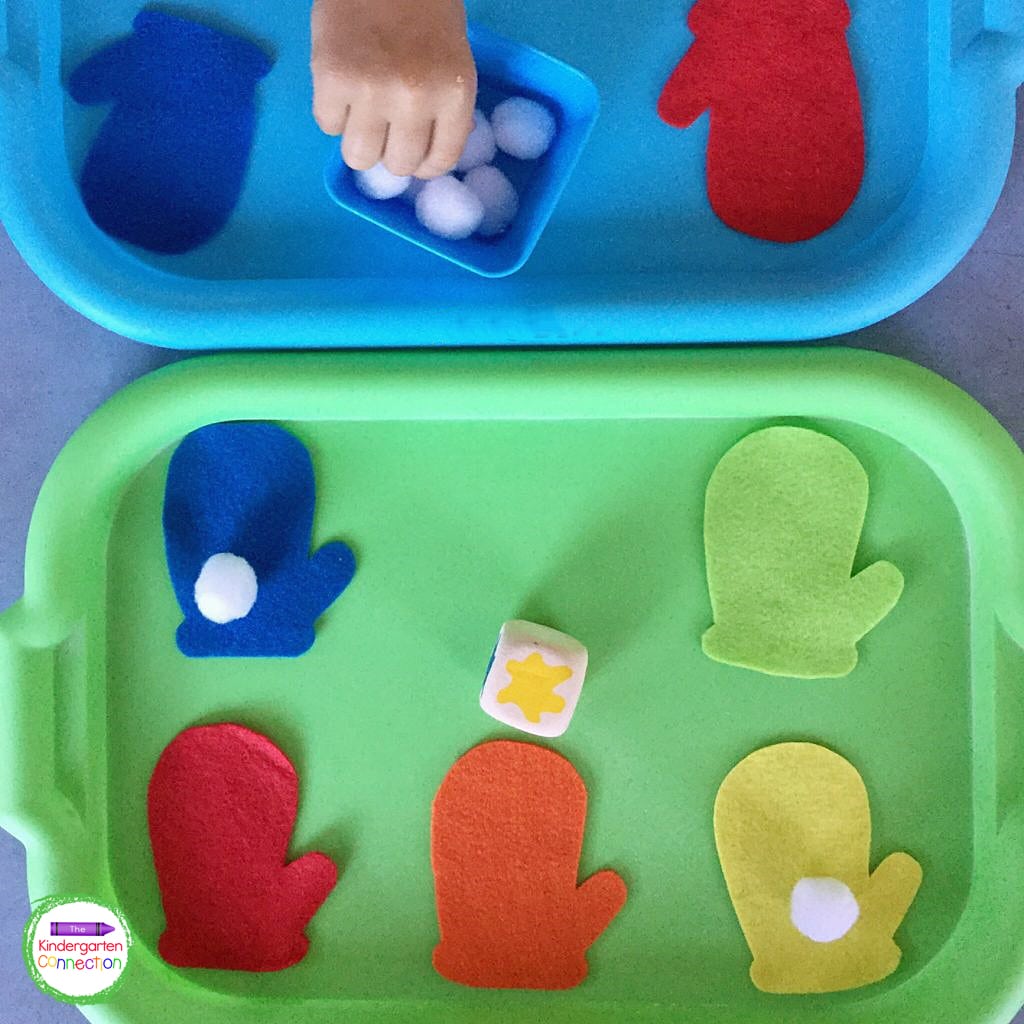 Students take turns rolling the color die and add a pom pom to the matching color mitten.