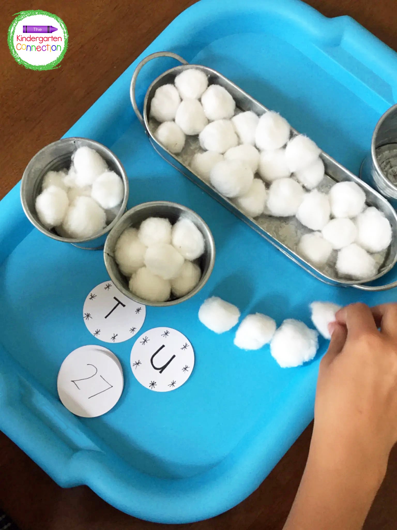Students will place ten cotton balls in each bucket to represent a ten. The ones go on the side.