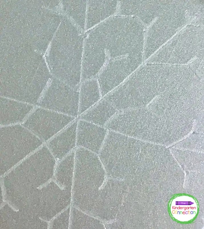 Next, invite students to use a dull pencil and press firmly into the foam plate to create their snowflake designs.