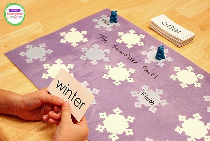 Players roll the die, read a sight word card, and move their pieces on the game board.