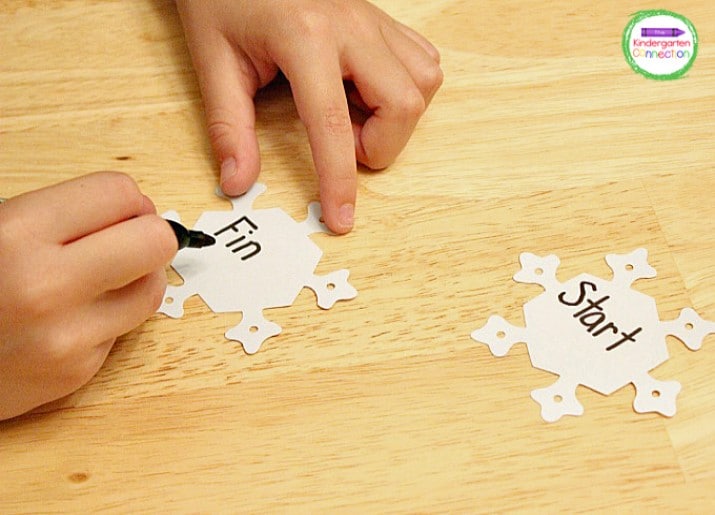 Write "Start" and "Finish" on a snowflake. Place these snowflakes where you want them on the game board.