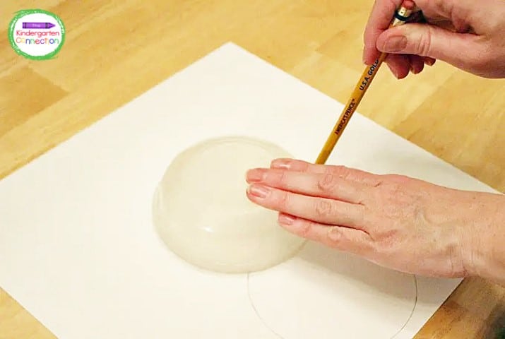 Using cardstock and the bottom of a small bowl, trace 2 large circles in the center of the paper.