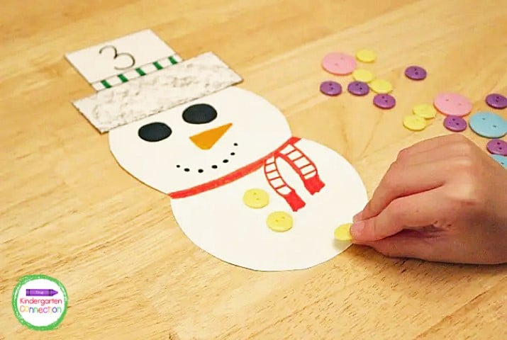The kids can pick a number top hat and then add that many buttons to their snowman!