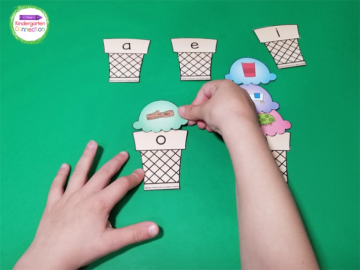 Students pick a CVC word ice cream scoop and place it on a letter cone based on the middle sound.