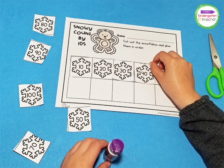 In this math printable for Kindergarten, kiddos cut and paste the snowflakes in order from 10-100.