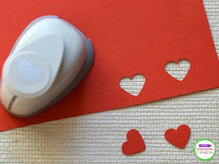 Use a heart craft punch to cut two heart-shaped eyes from the red paper. Glue them to the head of the bee.