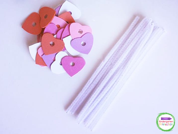 Next, make holes in each heart with a regular hole punch for the pipe cleaner to fit through.
