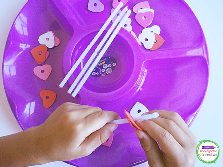 Add the heart and pipe cleaners to a tray as an invitation to play!