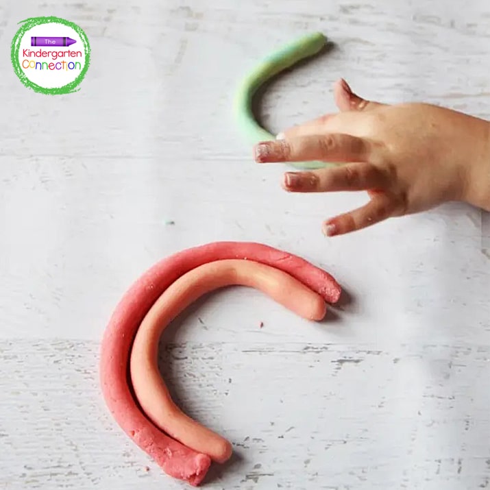 My kids loved using the rainbow play dough colors to roll snakes and form their own rainbows.