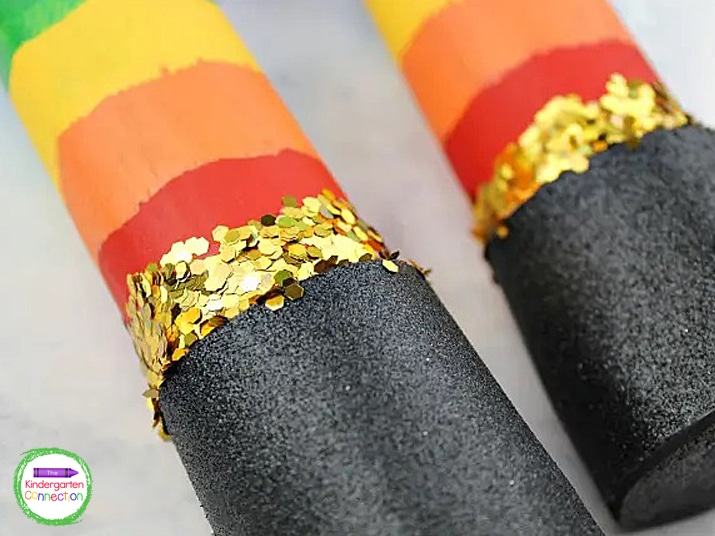 Add some glue above the black glitter foam all the way around the tube and sprinkle with gold glitter.
