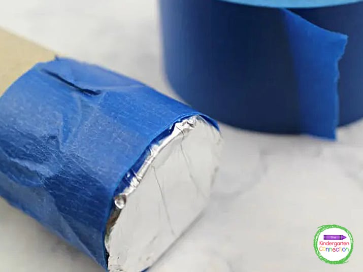 Cut squares of foil large enough to wrap around the end of the paper towel tube. Glue it in place and secure it with masking tape.