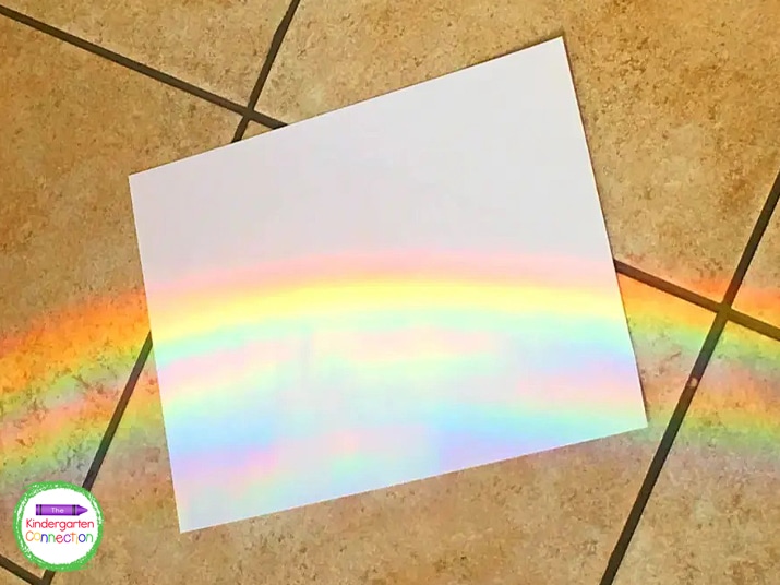 As the sunlight passes through the water, the sunlight is separated into a spectrum of colors forming a rainbow.