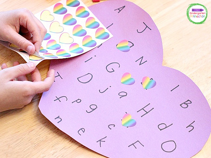 Next, they find the letter on the heart and cover it up with a heart sticker.
