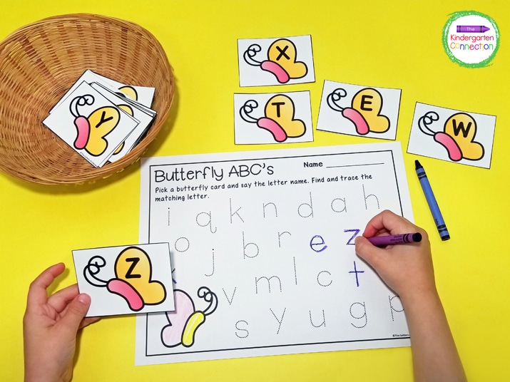 Kids pull a letter card and trace the letter on the Butterfly Alphabet recording sheet.