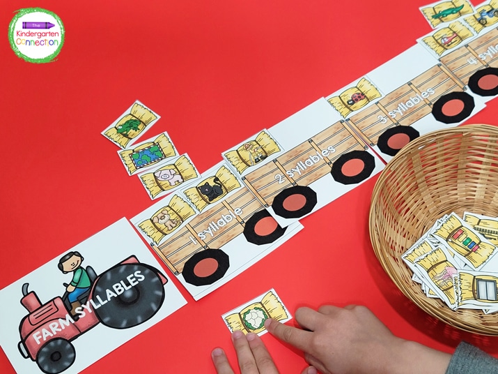 Lay out the tractor syllable cards and add the picture cards to a small basket.