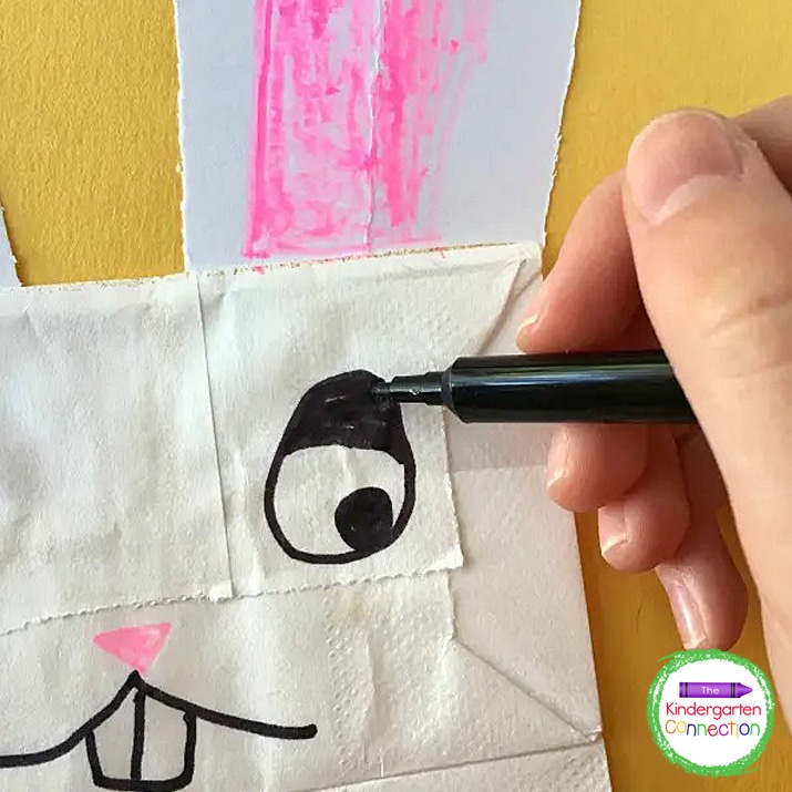 Using a black fine tip marker, students can add facial features like eyes and a mouth.