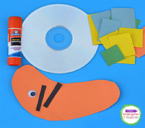 Begin by cutting small pieces of the construction paper to glue onto the CD/DVD.