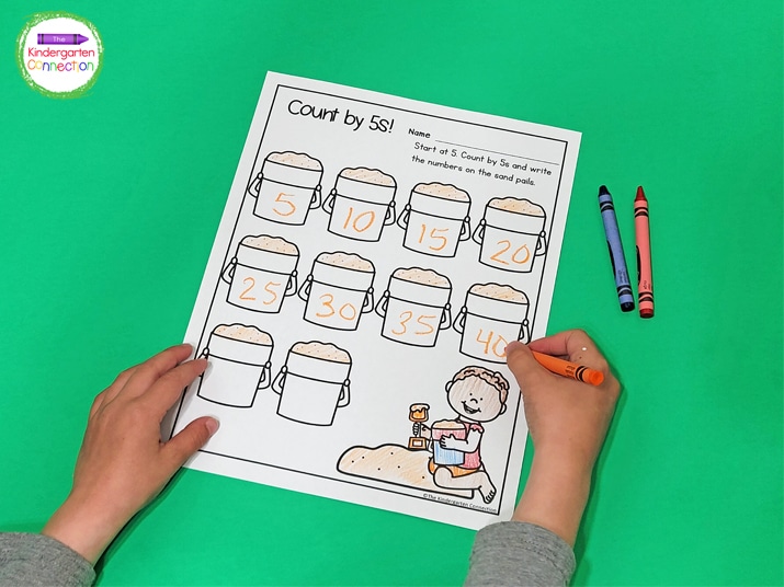 For this activity, kiddos simply count by 5’s and write the numbers on the sand pails.