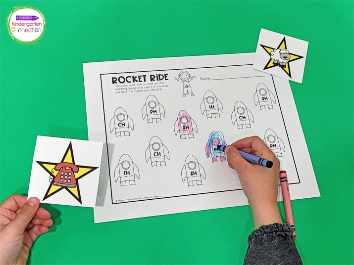 Kids continue picking star cards and coloring digraphs until all of the rockets on the recording sheet are colored.