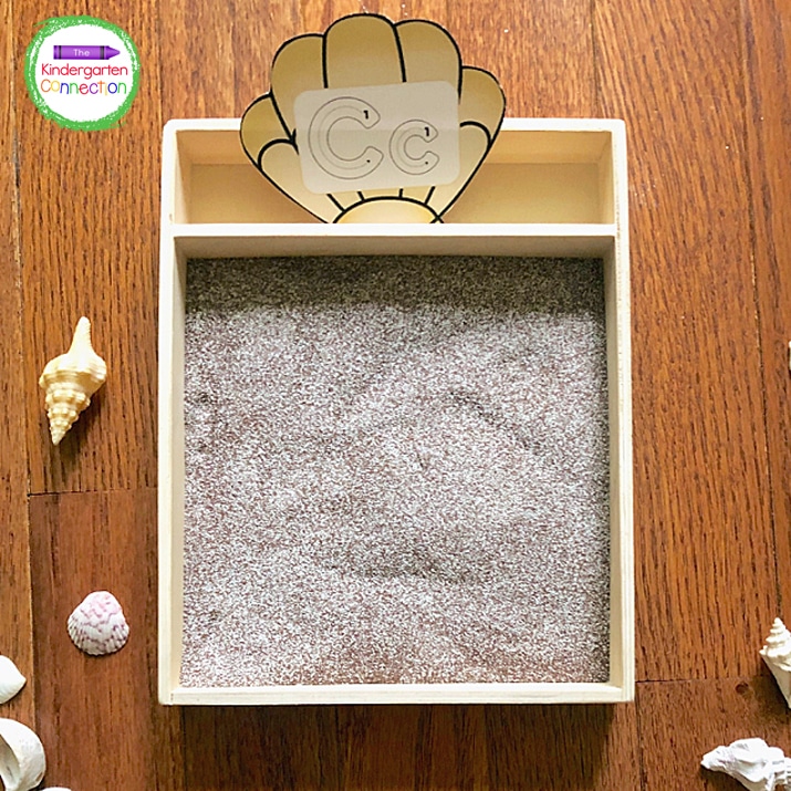 Students will pick a seashell letter card and lay it beside the tray or in the tray if there is a spot so they can see the letter. 