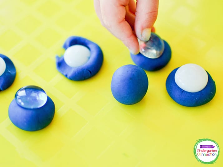 Kids will love pressing the glass beads into play dough balls.