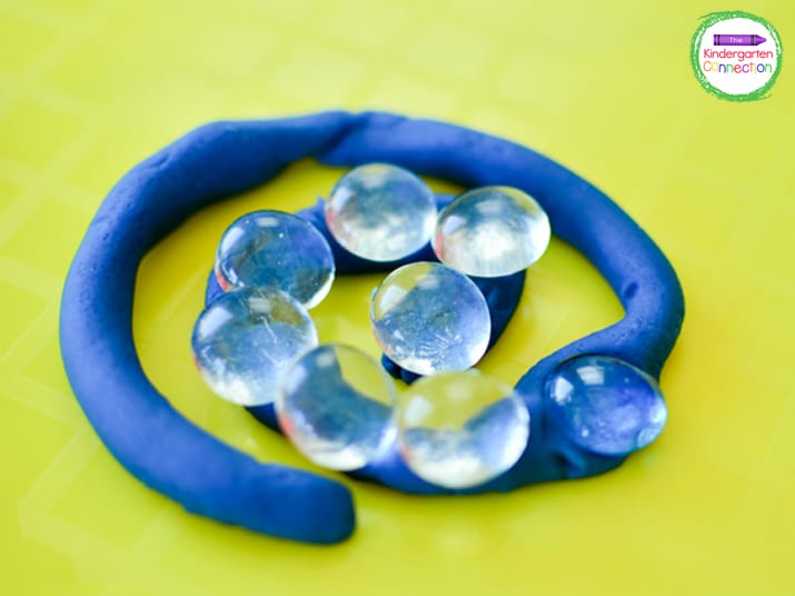 Spirals are a fun shape to make with the play dough before pressing the glass beads into them.