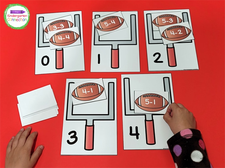 Students pick a football card, solve the equation, and place it with the field goal card that has the correct answer.