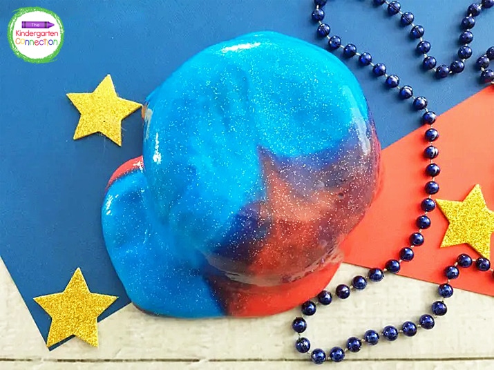 The glitter in the slime sparkles through the pretty blue and red colors.