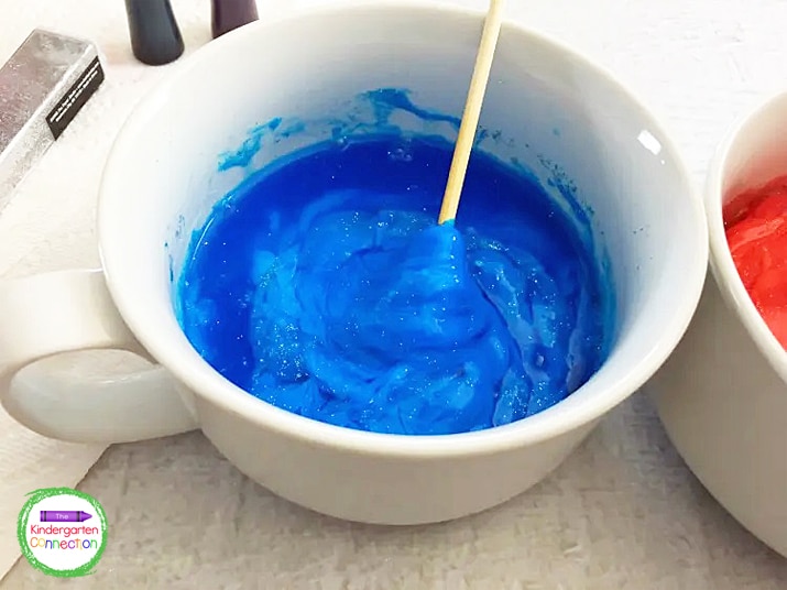 Pour half the borax water into your blue glue mixture and stir, and half into the red glue mixture and stir.